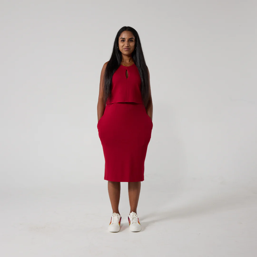Red dress with double layers that reveal a zip for easy removal of an ostomy bag and split hem for wheelchair users